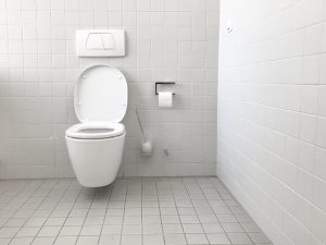 toilet in a clean white bathroom